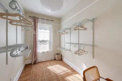 a room with shelves on the wall and a window at Bright & Modern - 35 Mins to NYC - Extended Stays in Jersey City