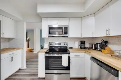 a kitchen with white cabinets and a stove top oven at Spacious 5BR Home In Heart Of Poconos By Camelback Skiing Swimming Lake in Tobyhanna
