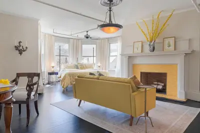 a bedroom with a bed and a couch and a fireplace at The Revival House in Adams
