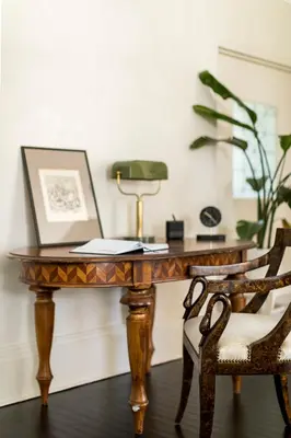 a wooden table with a desk with two chairs at The Revival House in Adams