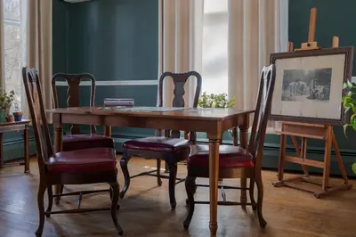 a dining room with a wooden table and chairs at The Revival House in Adams