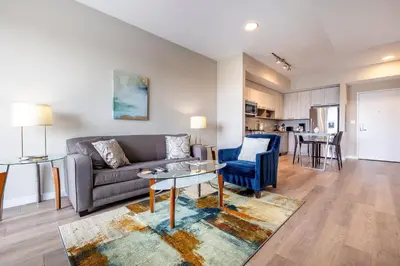 a living room with a couch and a table at Modern Apt with Harbor Views in South End