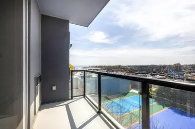 a balcony with a view of a swimming pool at Modern Apt with Harbor Views in South End