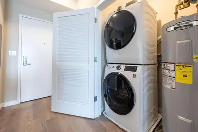 a washing machine and a dryer in a room at Modern Apt with Harbor Views in South End