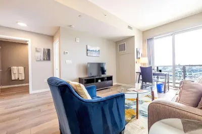 a living room with a couch and a table at Modern Apt with Harbor Views in South End