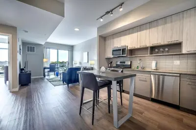 a kitchen with a table and a dining room at Modern Apt with Harbor Views in South End