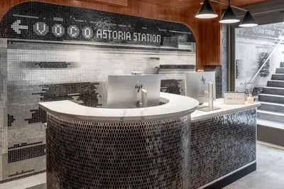 a bathroom with two sinks and a counter at voco Astoria by IHG in New York