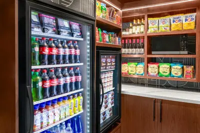 a refrigerator filled with lots of sodas and drinks at voco Astoria by IHG in New York
