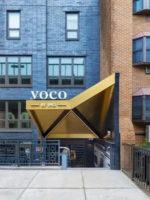 a voco sign in front of a building at voco Astoria by IHG in New York