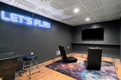 a room with a flat screen tv and a stage with two speakers at Vermont Retreat with private pool and tennis court in Wilmington