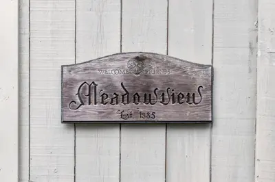 a sign on the side of a wooden wall at Vermont Retreat with private pool and tennis court in Wilmington