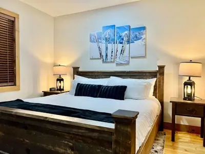 a bedroom with a large bed with two lamps at Luxury ADA Unit - 101 in Wilmington