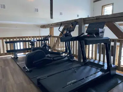 a gym with two exercise bikes on a treadmill at Luxury ADA Unit - 101 in Wilmington