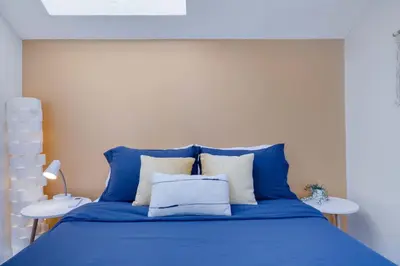 a blue bed with white pillows in a bedroom at Charming Lakeside Retreat for 10 in Tobyhanna