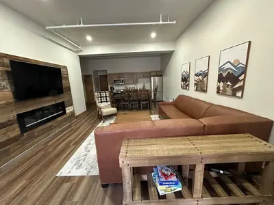 a living room with a couch and a table at Luxury Townhome 107 in Wilmington
