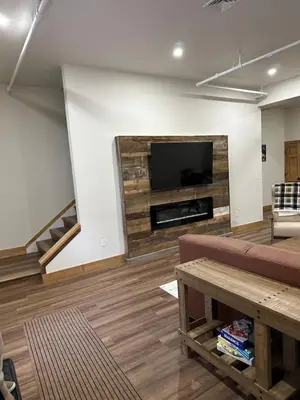 a living room with a couch and a flat screen tv at Luxury Townhome 107 in Wilmington