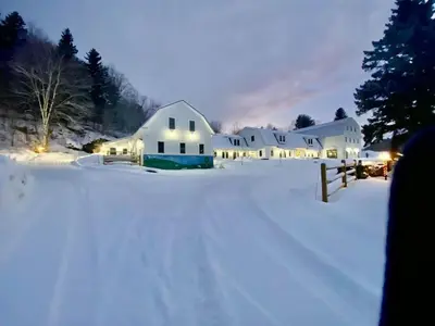 a white house in the snow at night at Luxury 1 Bedroom Lodge Unit 301 in Wilmington