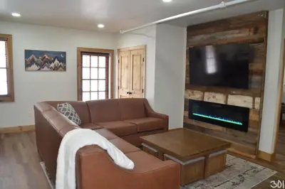 a living room with a couch and a flat screen tv at Luxury 1 Bedroom Lodge Unit 301 in Wilmington