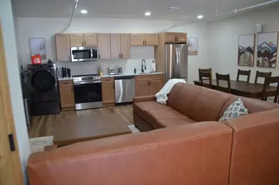 a living room with a couch and a kitchen at Luxury 1 Bedroom Lodge Unit 301 in Wilmington