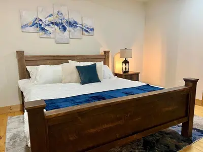 a bedroom with a large bed with blue and white pillows at Luxury 2 Bedroom Lodge Unit 302 in Wilmington