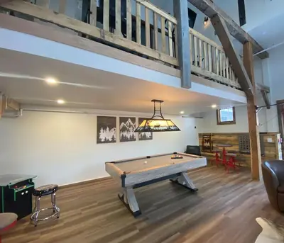 a pool table in a living room with a loft at Luxury 2 Bedroom Lodge Unit 302 in Wilmington