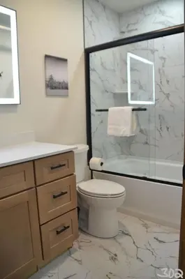 a bathroom with a toilet and a glass shower at Luxury 2 Bedroom Lodge Unit 302 in Wilmington