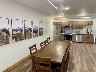 a kitchen and dining room with a wooden table and chairs at Luxury 2 Bedroom Lodge Unit 302 in Wilmington
