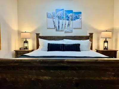 a bedroom with a large bed with two lamps at Luxury Townhome 105 in Wilmington