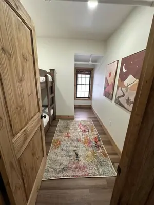 a hallway with a door and a rug on the floor at Luxury Townhome 105 in Wilmington