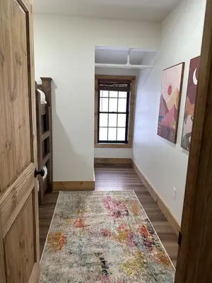 an empty hallway with a window and a rug on the floor at Luxury Townhome 105 in Wilmington
