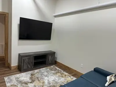 a living room with a flat screen tv on a wall at Luxury TownHome 106 in Wilmington