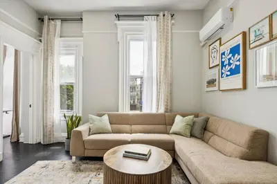 a living room with a couch and a table at Chic & Modern - 30 Mins to NYC in Jersey City