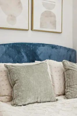 a bed with two pillows and two pictures on the wall at Chic & Modern - 30 Mins to NYC in Jersey City