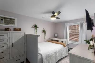 a bedroom with a bed and a ceiling fan at Cozy meets fun! in Beacon