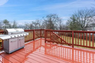 a stove on a deck with a fence at Cozy meets fun! in Beacon
