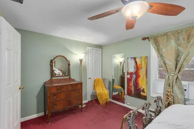 a bedroom with a bed and a dresser and a mirror at Cozy meets fun! in Beacon