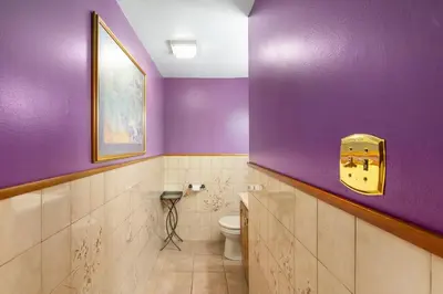 a bathroom with purple walls and a toilet at Cozy meets fun! in Beacon
