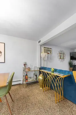 a living room with a table and a basketball hoop at Cozy meets fun! in Beacon