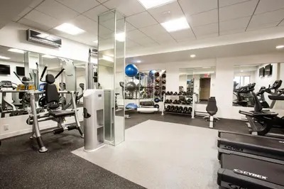 a gym with treadmills and machines in a room at Murray Hill Studio w Gym Doorman nr 6 train NYC-628 in New York