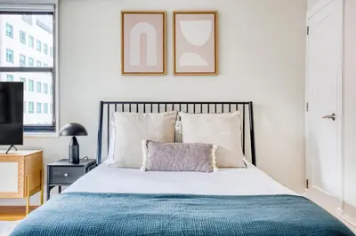 a bedroom with a bed with a blue blanket at Murray Hill Studio w Gym Doorman nr 6 train NYC-628 in New York