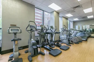 a row of cardio machines in a gym at Tribeca Studio w City views Gym Pool NYC-110 in New York