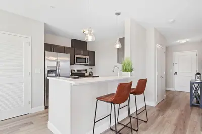 a kitchen with two bar stools and a counter top at Downtown NWK 1BR- Free Parking Easy NYC Access in Newark