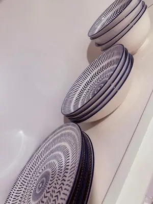 three plates sitting on top of a white table at le plateau suite in Queens