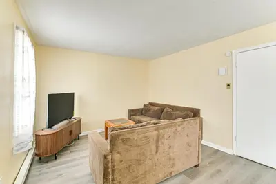 a living room with a couch and a flat screen tv at Near Hospitals Home with Yard in Albany! in Albany