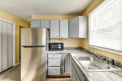 a kitchen with a stainless steel refrigerator and a sink at Near Hospitals Home with Yard in Albany! in Albany