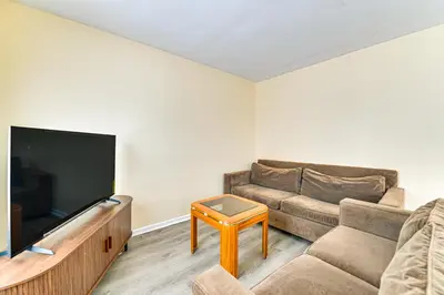 a living room with a couch and a flat screen tv at Near Hospitals Home with Yard in Albany! in Albany