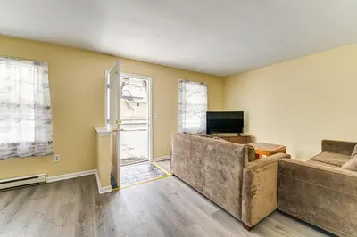 a living room with a couch and a television at Near Hospitals Home with Yard in Albany! in Albany