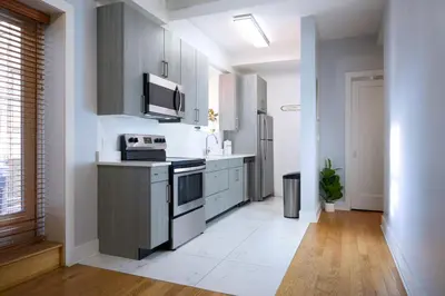 a kitchen with a stove and a microwave at Fordham University in University Heights
