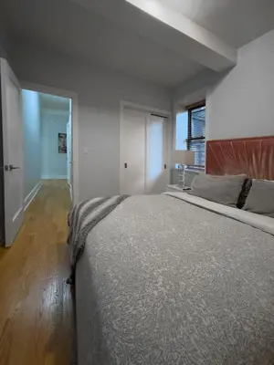 a bedroom with a large bed and a window at Fordham University in University Heights