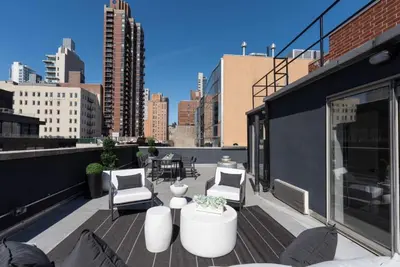 a balcony with chairs and tables on a building at 3BR Penthouse Suite with Massive Private Rooftop in New York